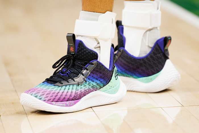 View of black and purple Curry shoes.
